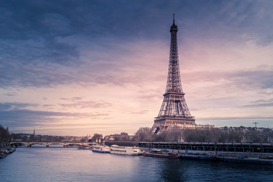 The Eiffel Tower rising over the River Seine at dusk in Paris